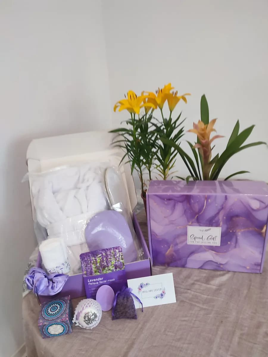 lavender spa gift box unboxed with bathrobe, sheet mask, card and bath bomb
