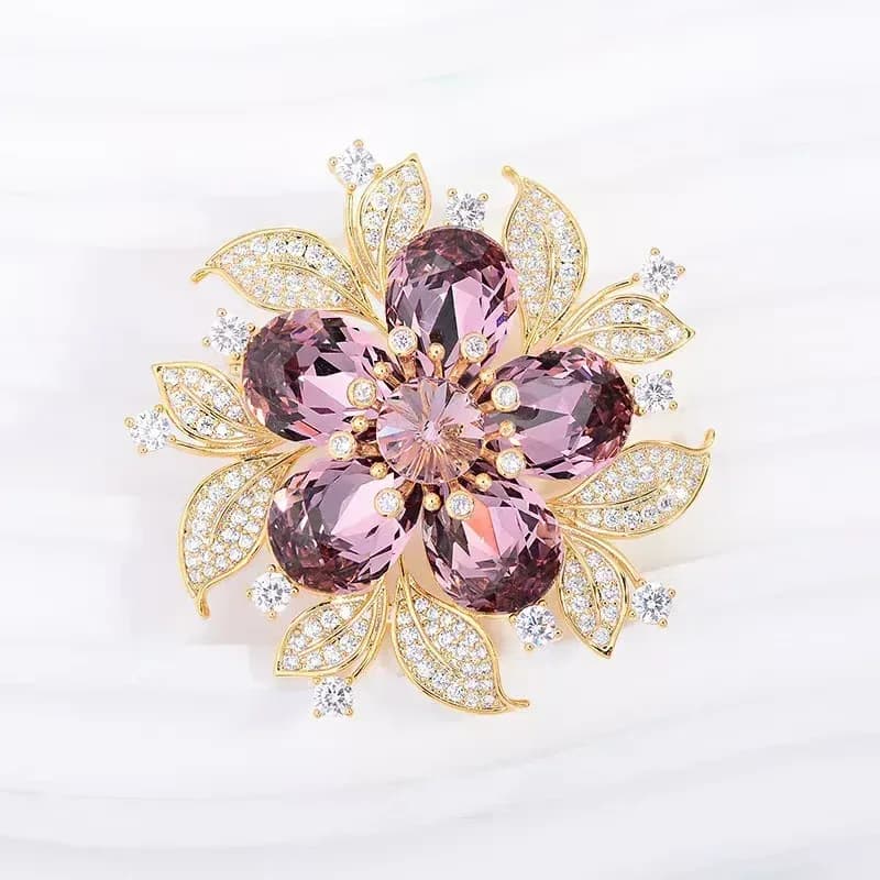 rhinestone flower brooch with purple faceted stones in gold tone