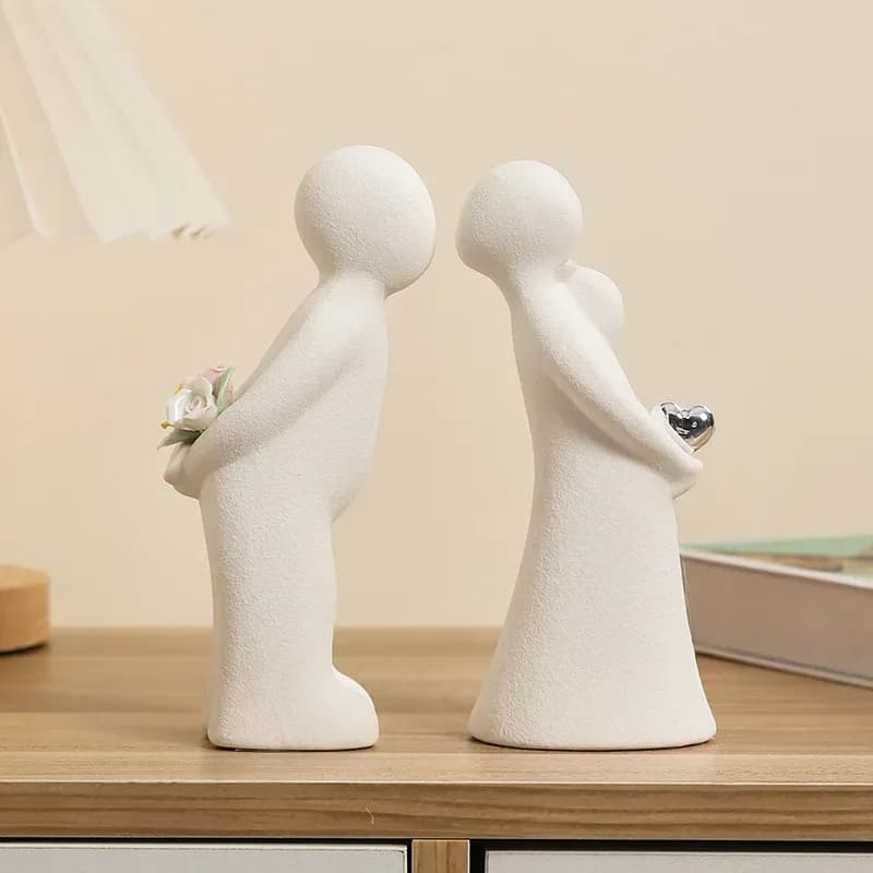 kissing couple ceramic figurines, set of 2, on a shelf