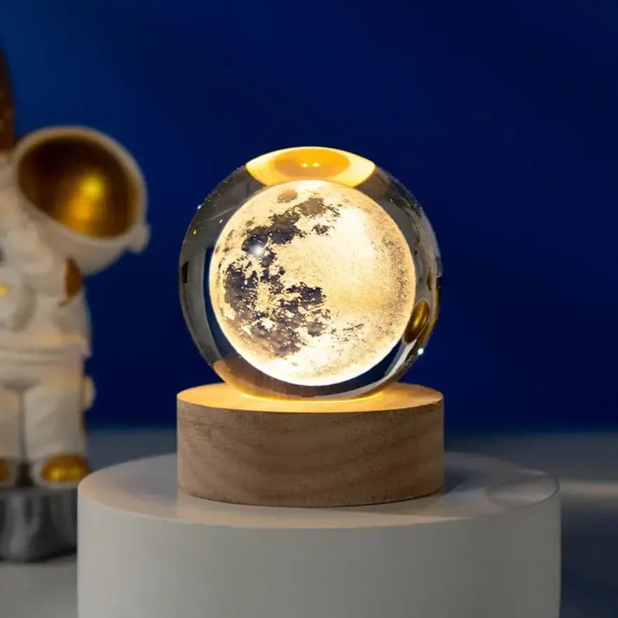 3D crystal ball night light with engraved full moon on a wooden base